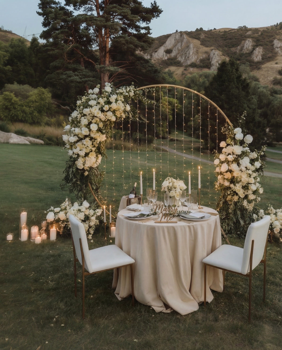 Tiani Luxurious proposal experience by Tiani Jewellery featuring a floral circular backdrop, candlelit styling and romantic dinner setup.